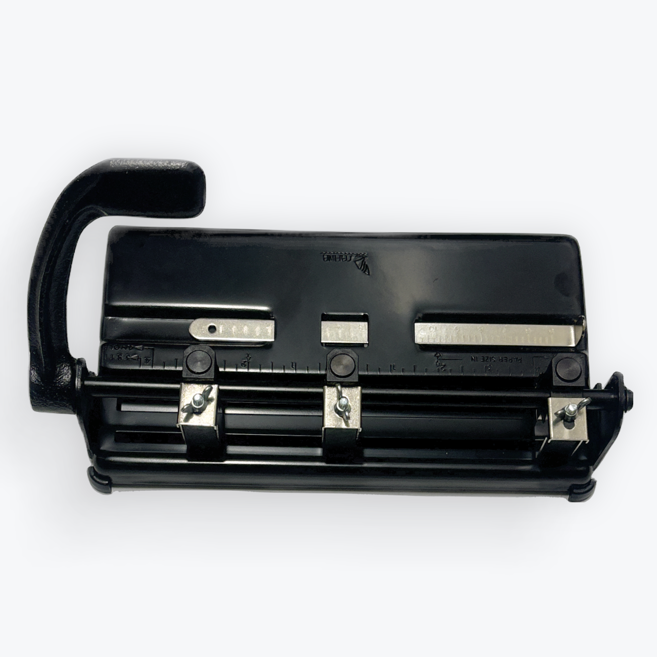 A black office punch hole machine with a curved handle, shown from a top-down angle on a light gray background.