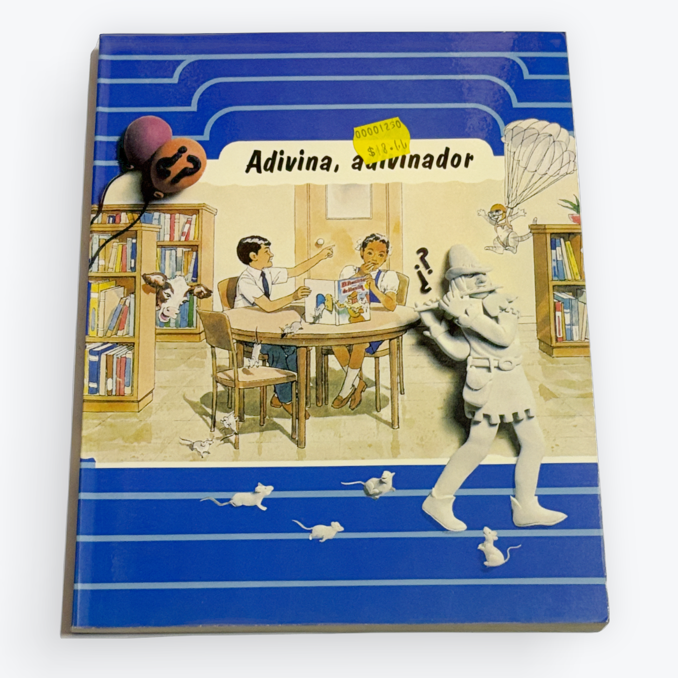 A vintage Spanish-language book titled 'Adivina, adivinador' with a colorful illustrated cover featuring a bookshelf scene and a rabbit, photographed on a clean white background.