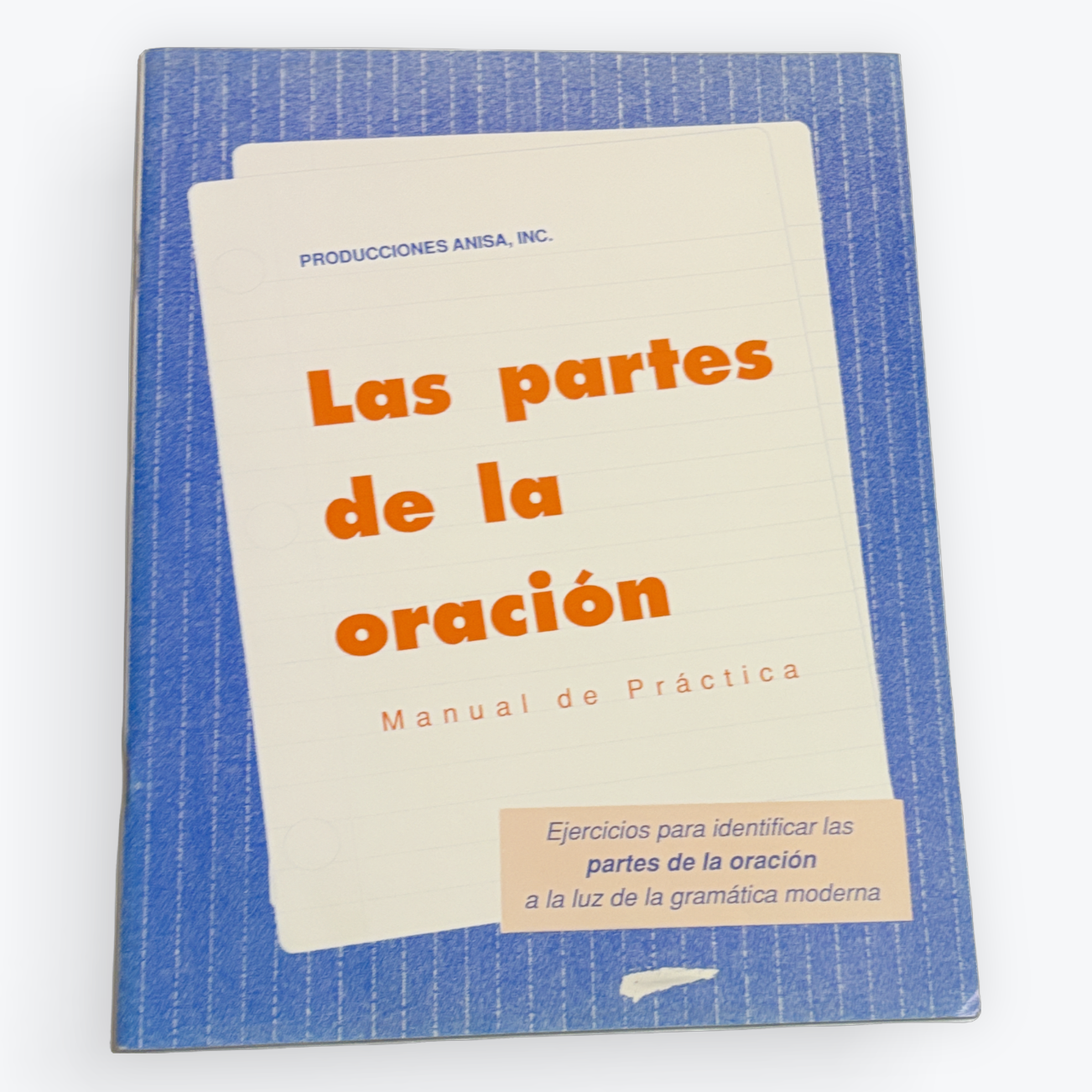 A book titled 'Las partes de la oración' by Producciones Audio, Inc., featuring a blue textured cover with a cream-colored title card and orange text.