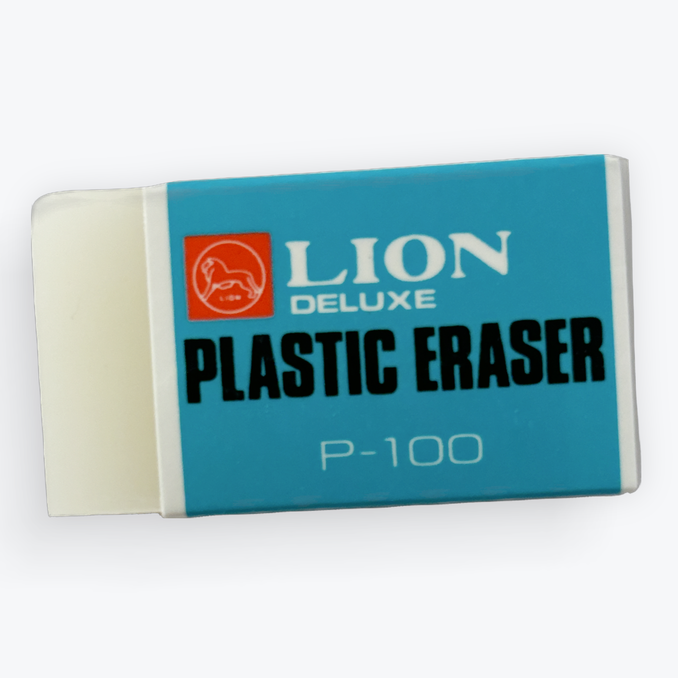 A classic Lion Deluxe plastic eraser, model P-100, featuring a teal blue paper sleeve with white and black text and a cream-colored plastic core visible on the left.