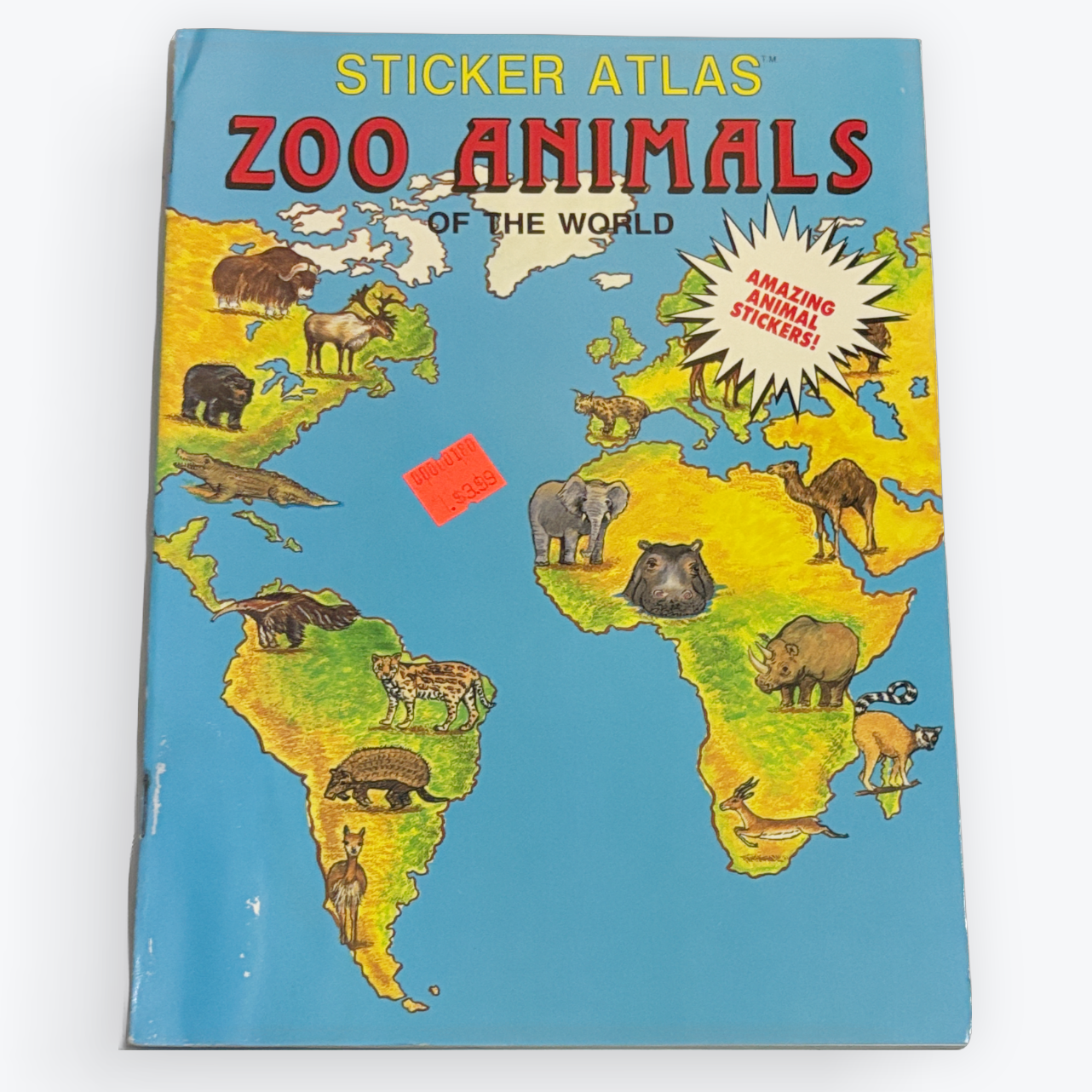 Vintage 'Sticker Atlas Zoo Animals of the World' book with a colorful world map cover, displayed on a clean white background.