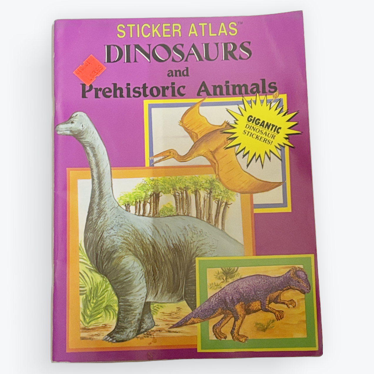 A children's sticker atlas titled 'Sticker Atlas Dinosaurs and Prehistoric Animals' on a light gray background. The book cover is purple with colorful dinosaur illustrations and a yellow 'Siganth' starburst sticker.